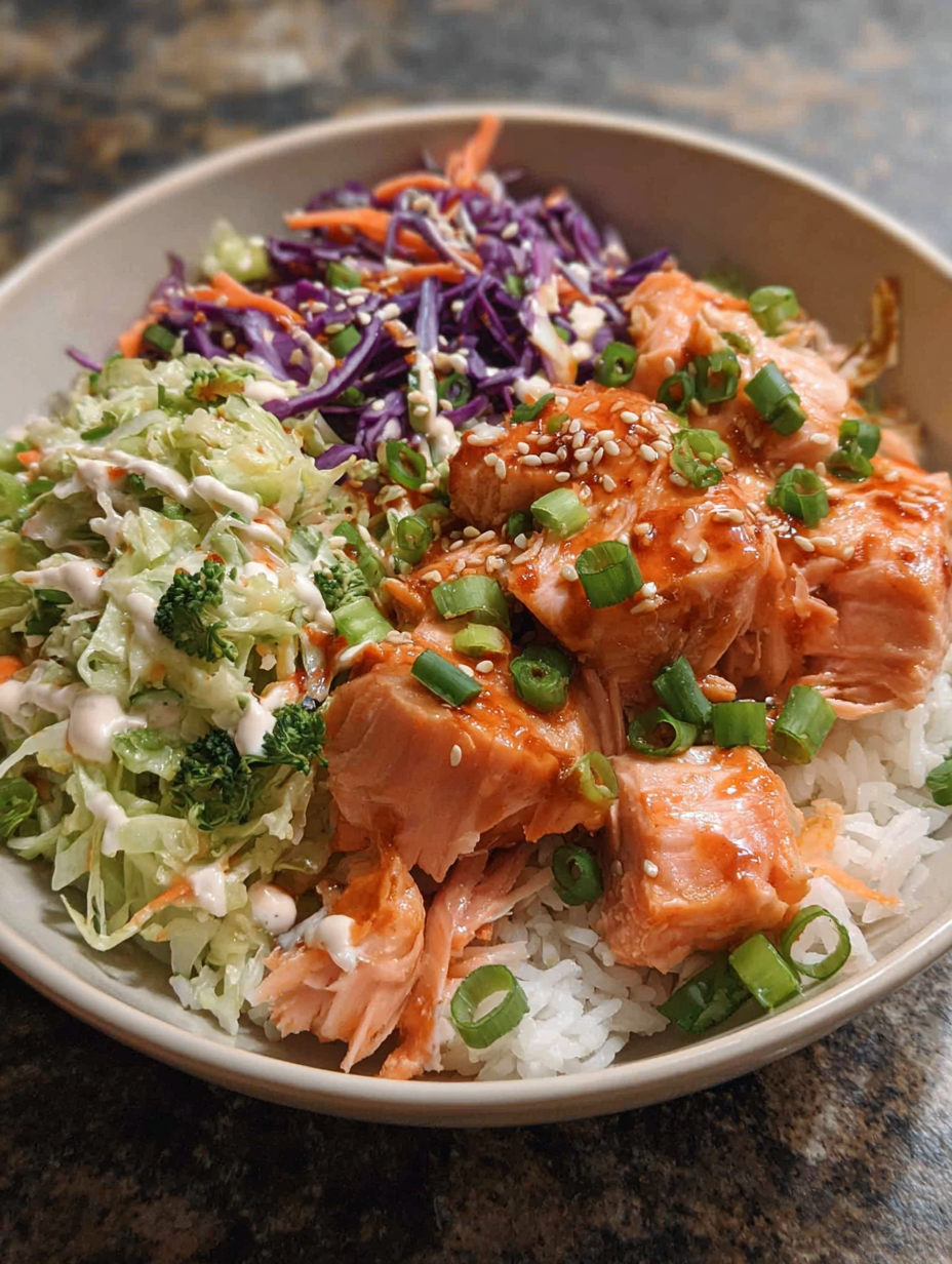 A spicy salmon bowl with rice and vegetables.