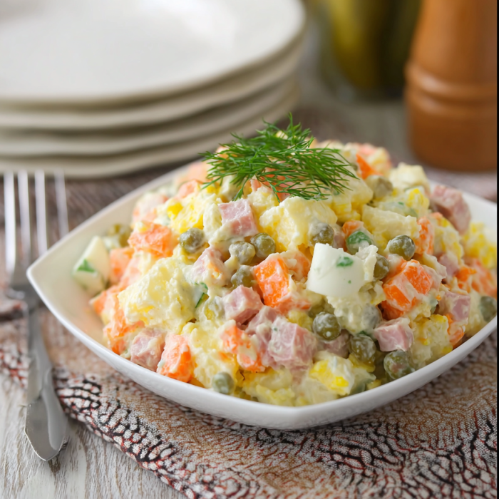 A white plate with a salad on it.