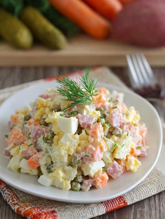 A white plate with a salad on it.
