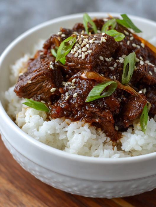 A bowl of rice and meat.