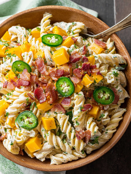 A bowl of pasta salad with jalapenos and bacon.