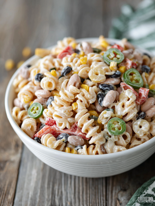 A bowl of pasta with corn and beans.