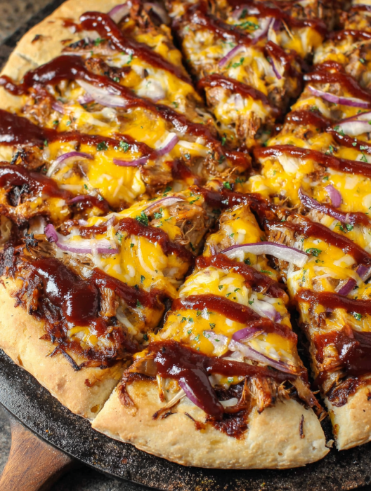 A pizza with meat and onions.