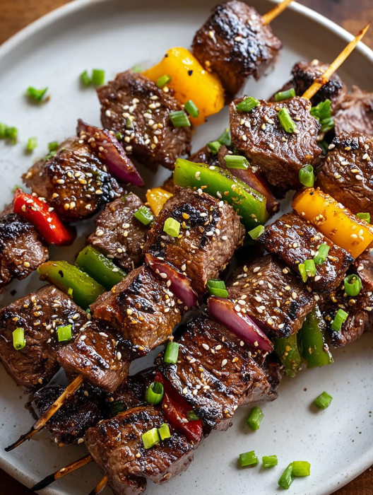 A plate of meat with peppers and onions.