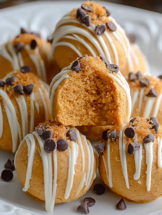 A plate of desserts with white icing and chocolate chips.