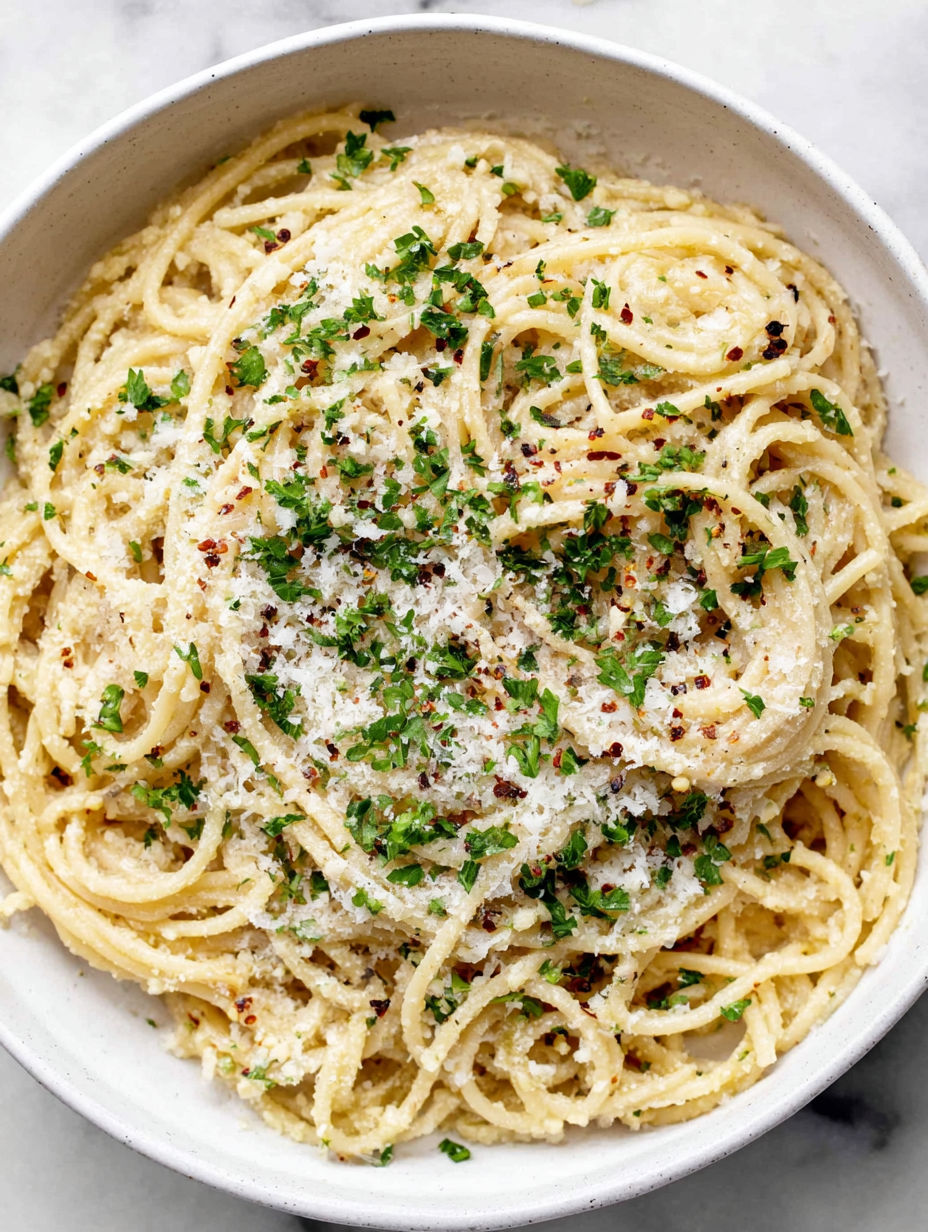 A bowl of pasta with garlic and Parmesan cheese.