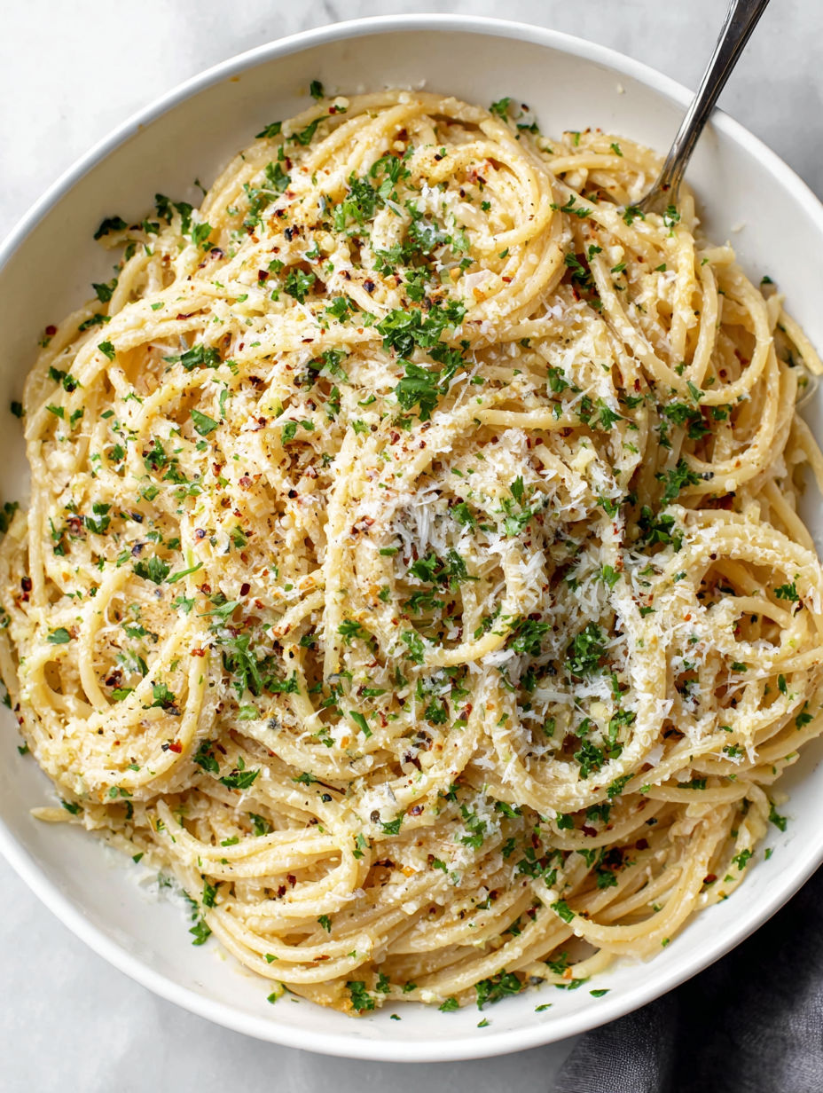 A bowl of pasta with garlic and Parmesan cheese.