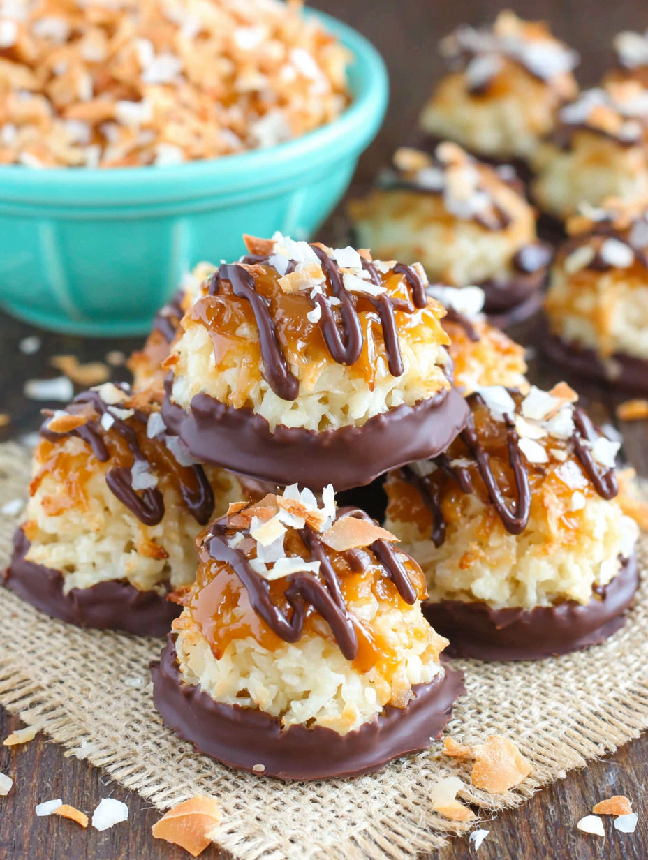 A bowl of coconut macaroons with chocolate drizzle.