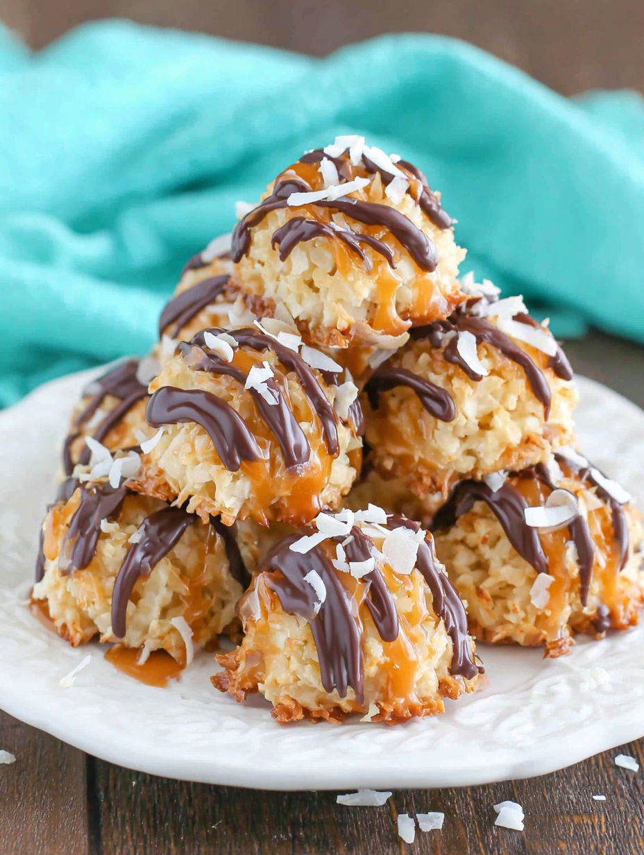 A stack of coconut macaroons with chocolate drizzle.