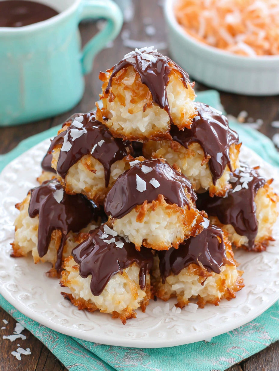 A stack of chocolate covered cream puffs.