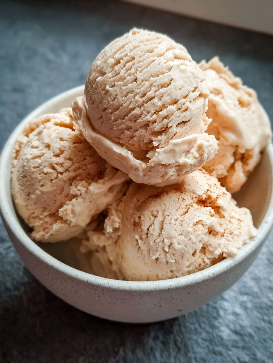 A bowl of ice cream with chocolate chips.