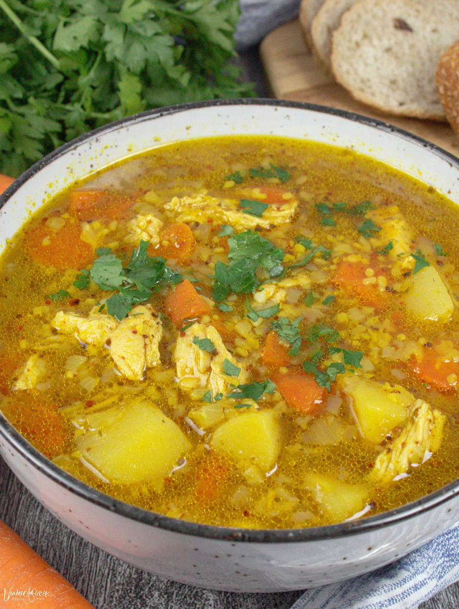 A bowl of soup with vegetables and meat.