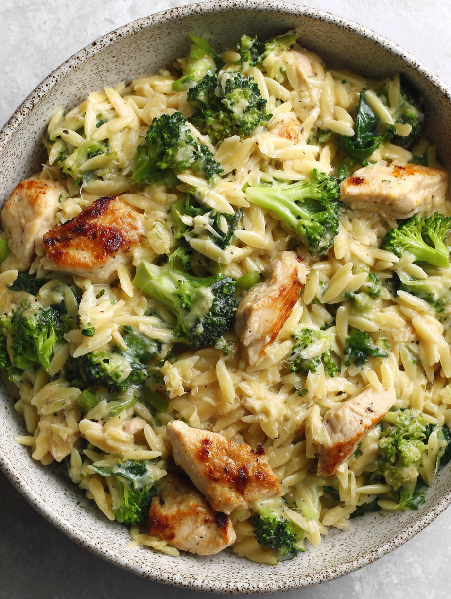 A bowl of pasta with chicken and broccoli.