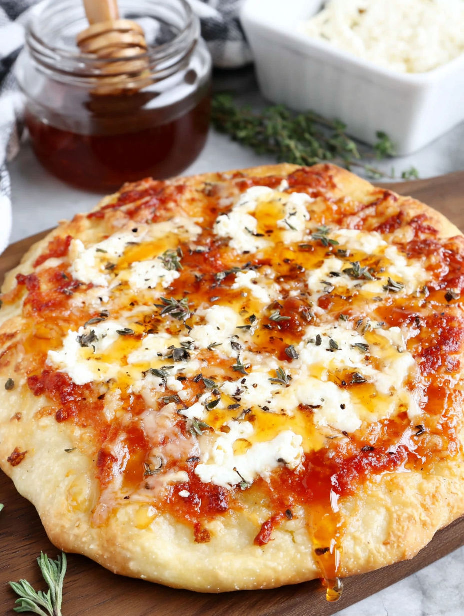 A pizza with cheese and sauce on a wooden board.