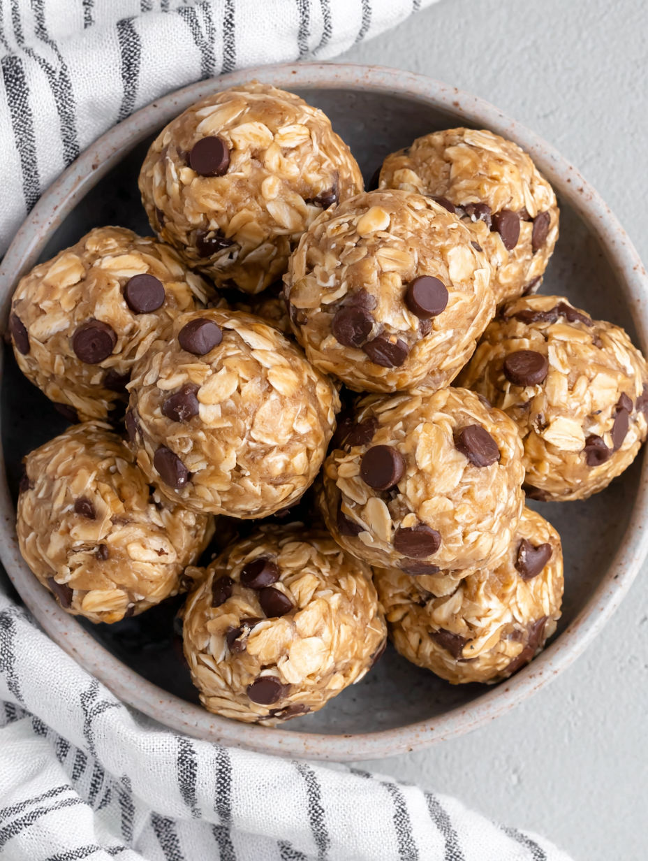 A bowl of granola balls with chocolate chips.