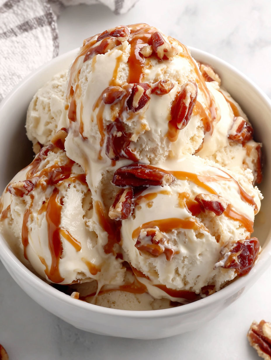 A bowl of ice cream with caramel drizzled on top.