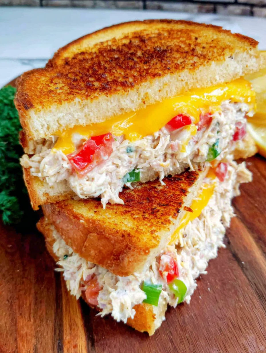 A sandwich with chicken, tomatoes, and peppers.