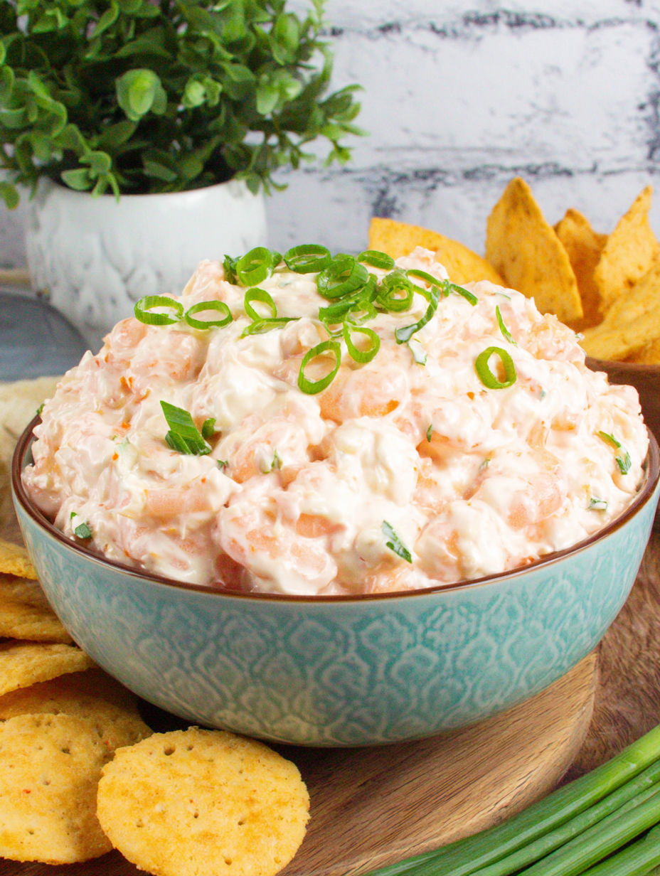 A bowl of shrimp salad with green onions.