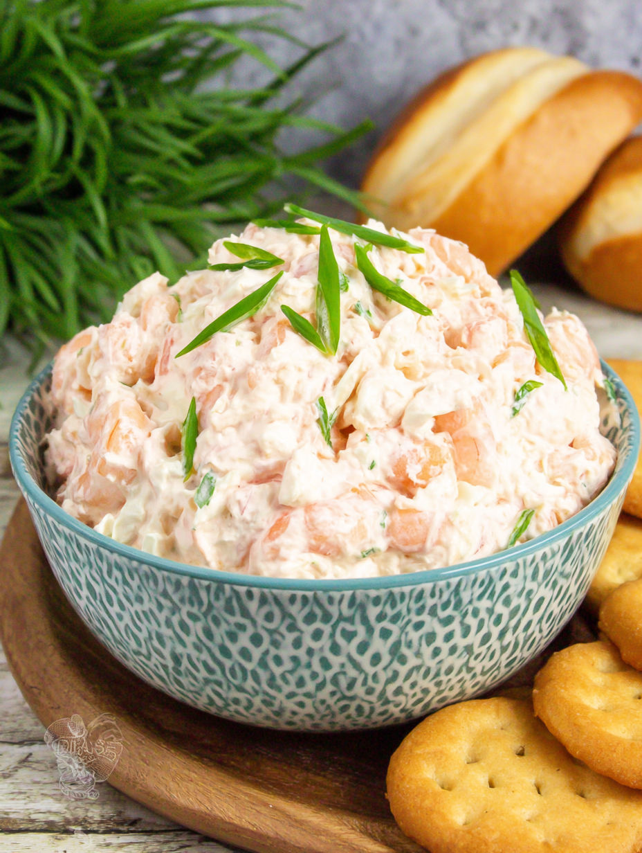 A bowl of coleslaw with green onions on top.