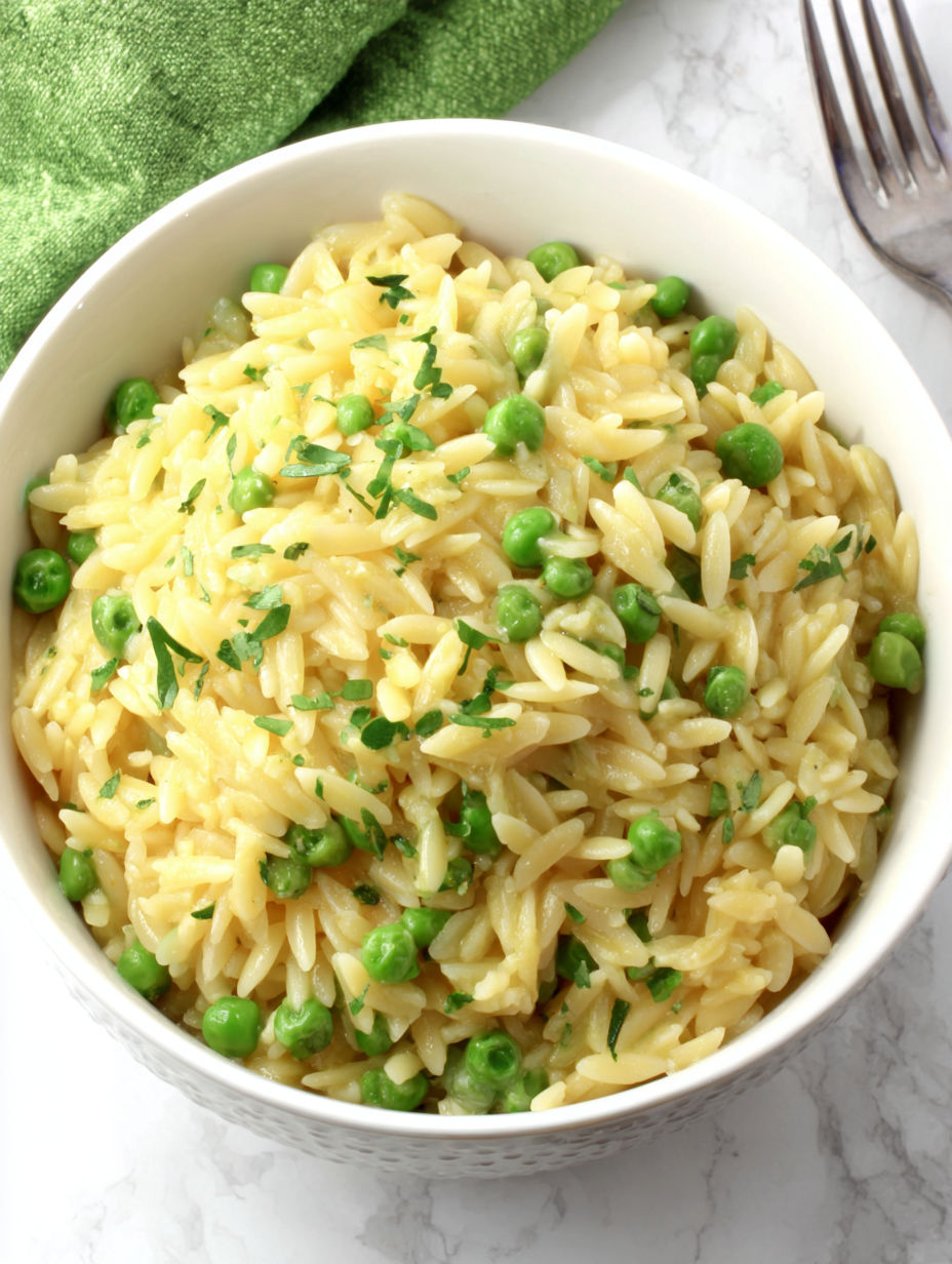 A bowl of rice with peas and herbs.