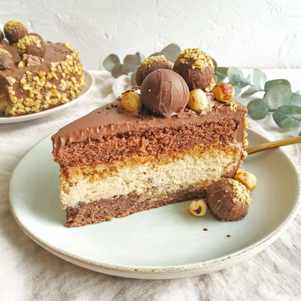 A slice of chocolate cake with nuts on top.
