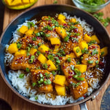 A pan of Asian Mango Chicken with rice.