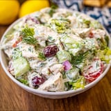 A bowl of chicken salad with garnish.