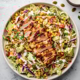 A bowl of spicy ranch chopped chicken cabbage salad.