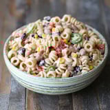 A bowl of pasta salad with corn, tomatoes, and black beans.