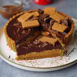 A slice of a no-bake biscoff tart.