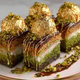 A chocolate dessert with gold flakes on top.