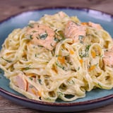 A plate of pasta with salmon and herbs.