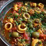 A spicy calamari stew with olives and tomatoes.