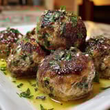A plate of meatballs with sauce.