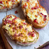 Two slices of bread with cheese and ham on top.