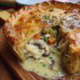 A close up of a pizza with mushrooms and carrots.