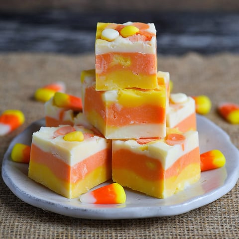 A plate of Halloween fudge with candy corn on top.