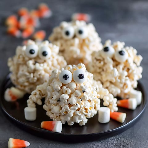 Halloween popcorn balls on a plate.