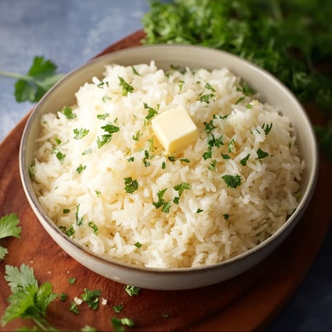 A bowl of rice with butter on top.