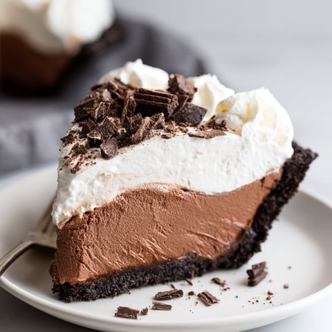 A slice of French Silk pie with chocolate and white cream.