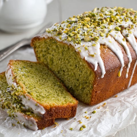 A loaf of bread with green topping.