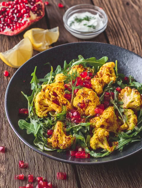 A plate of food with a lemon wedge on it.
