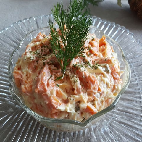 A glass bowl filled with a salad.