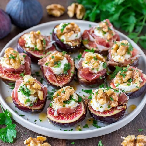 A plate of figs with goat cheese and Spanish jamon.