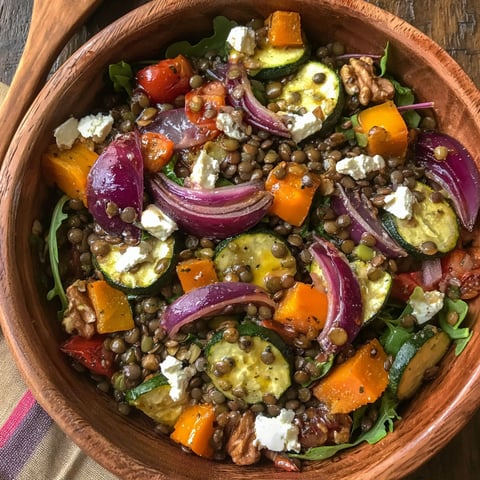 A bowl of roasted vegetable lentil salad with maple-mustard dressing.