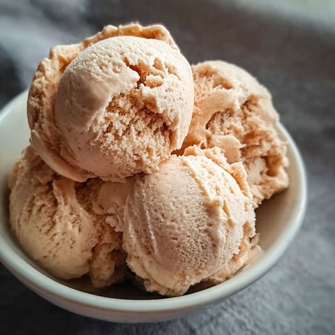 A bowl of ice cream with chocolate chips.