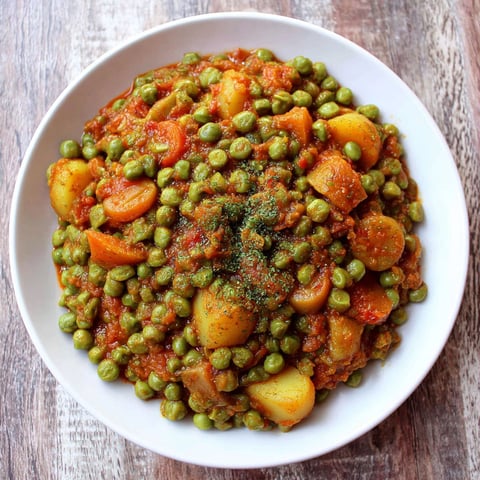 A white plate with a Greek style peas dish.