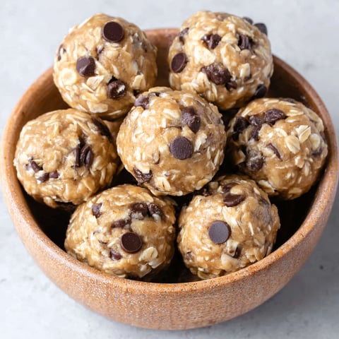 A bowl of oatmeal balls with chocolate chips.