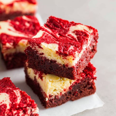 A close up of a red velvet cheesecake brownie.