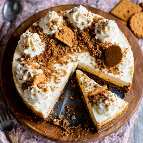 A slice of cake with white frosting and crumbs.